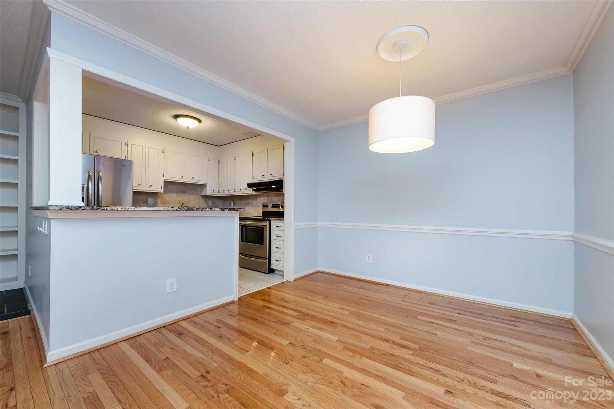 1336 Queens Road Charlotte, NC 28207 - Photo 17 of 36 a kitchen with granite countertop a sink cabinets stainless steel appliances and a window