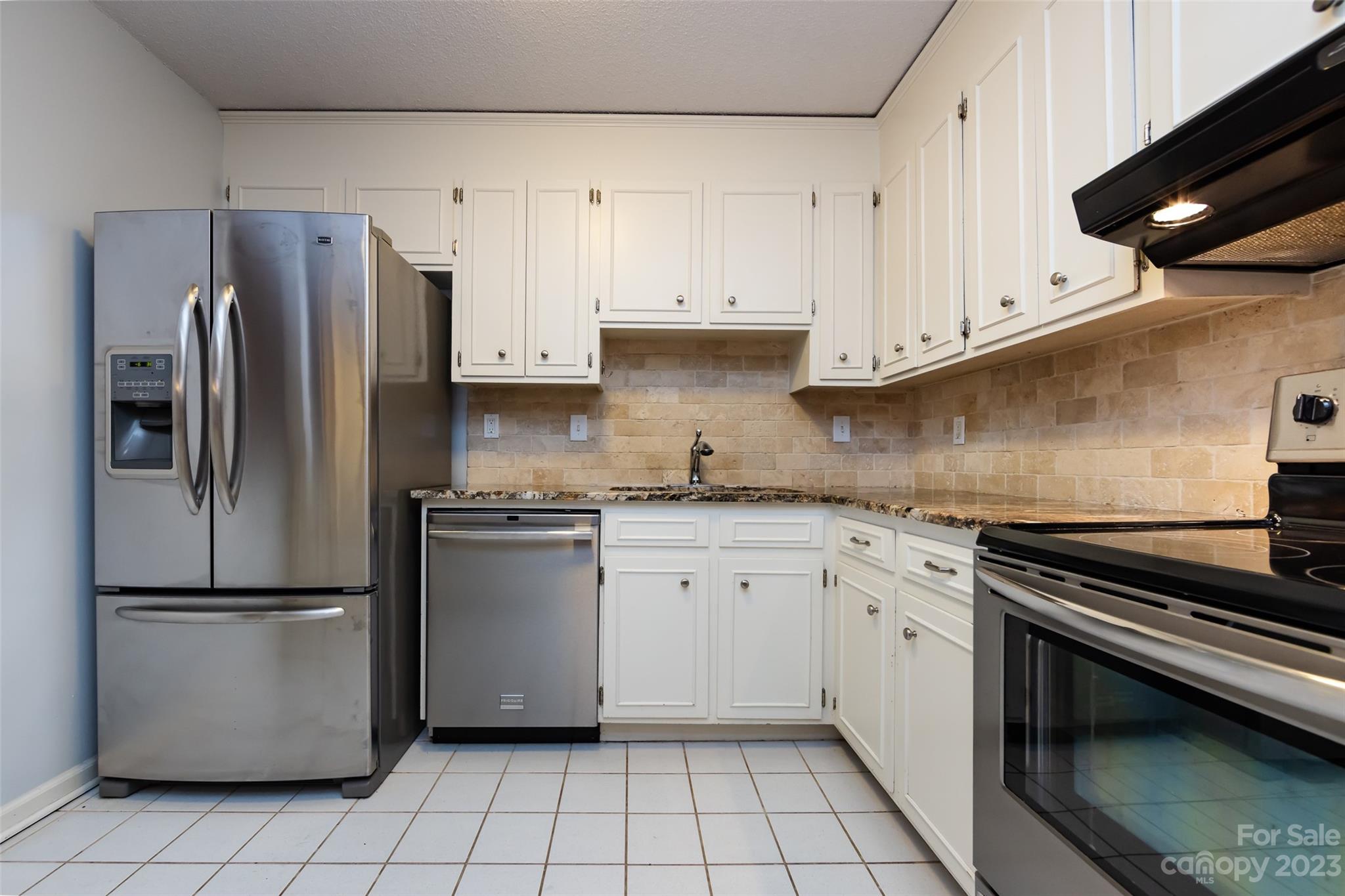 1336 Queens Road Charlotte, NC 28207 - Photo 20 of 36 a kitchen with a refrigerator sink and cabinets