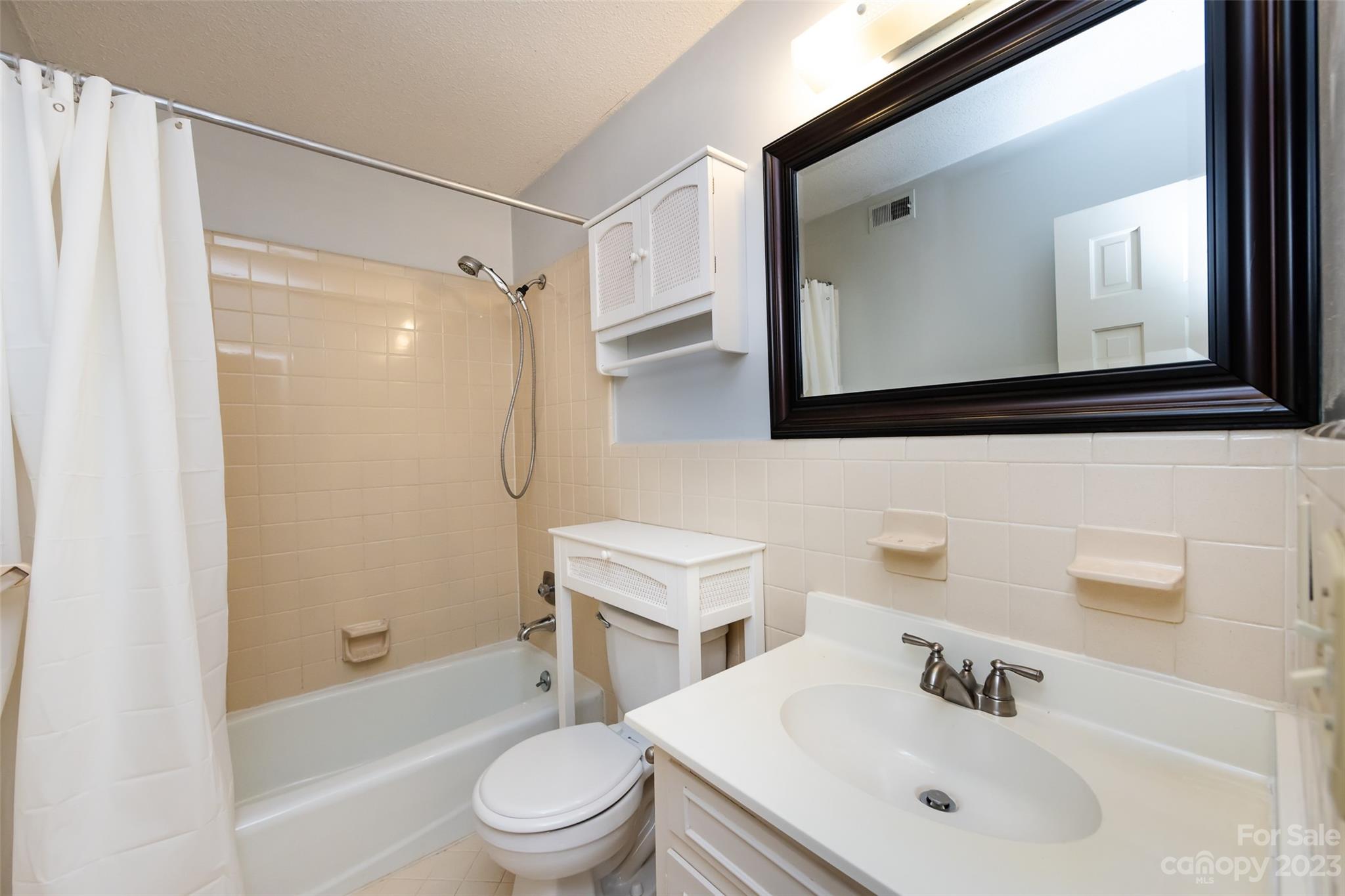 1336 Queens Road Charlotte, NC 28207 - Photo 28 of 36 a bathroom with a sink toilet a mirror and shower