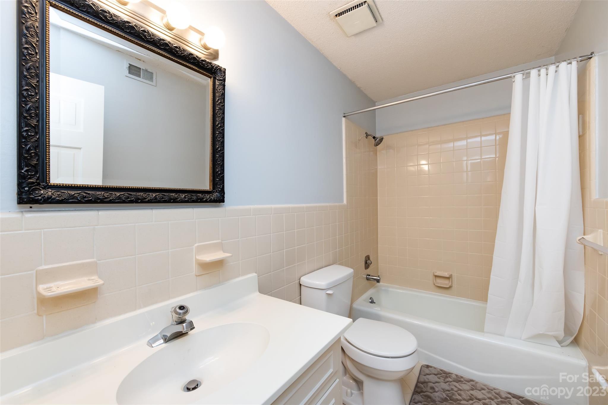 1336 Queens Road Charlotte, NC 28207 - Photo 33 of 36 a bathroom with a sink and a mirror