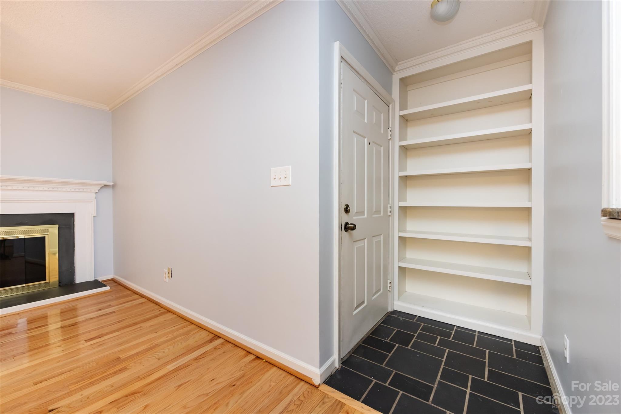 1336 Queens Road Charlotte, NC 28207 - Photo 8 of 36 a view of empty room with wooden floor and fireplace