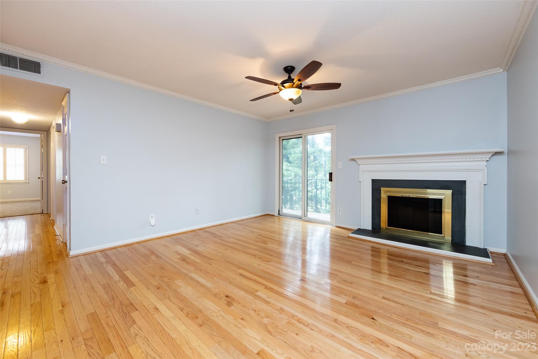 1336 Queens Road Charlotte, NC 28207 - Photo 9 of 36 a view of empty room with wooden floor and fireplace