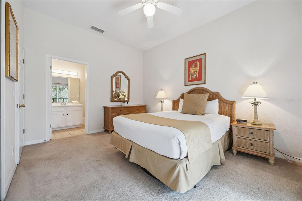 314 Lucaya Loop Davenport, FL 33897 - Photo 14 of 47 a bedroom with a bed and a chandelier