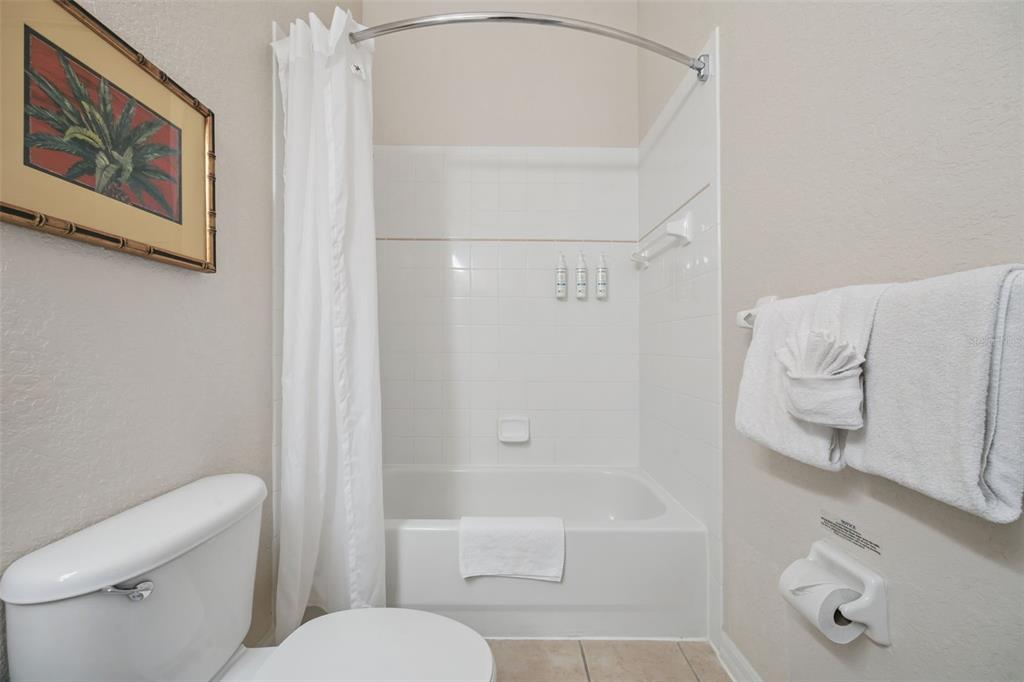 314 Lucaya Loop Davenport, FL 33897 - Photo 24 of 47 a white toilet sitting next to a bath tub shower