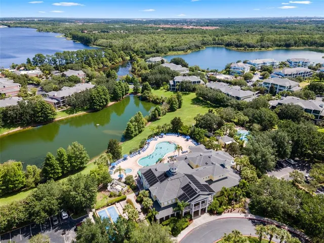 an aerial view of house with outdoor space and lake view