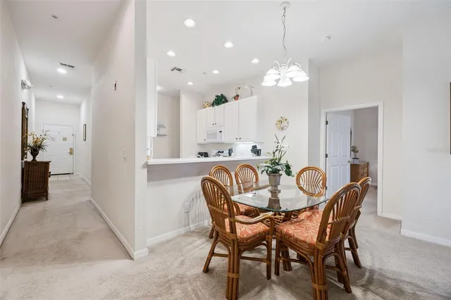 a dining room with furniture and chandelier