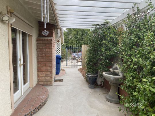 1006 North Sierra View Street Ridgecrest, CA 93555 - Photo 32 of 36 a view of a patio with table and chairs and potted plants