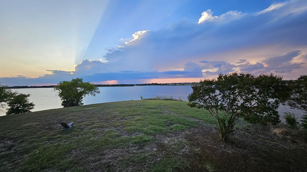 13280 Beach Club Road The Colony, TX 75056 - Photo 7 of 40 a night view of a lake