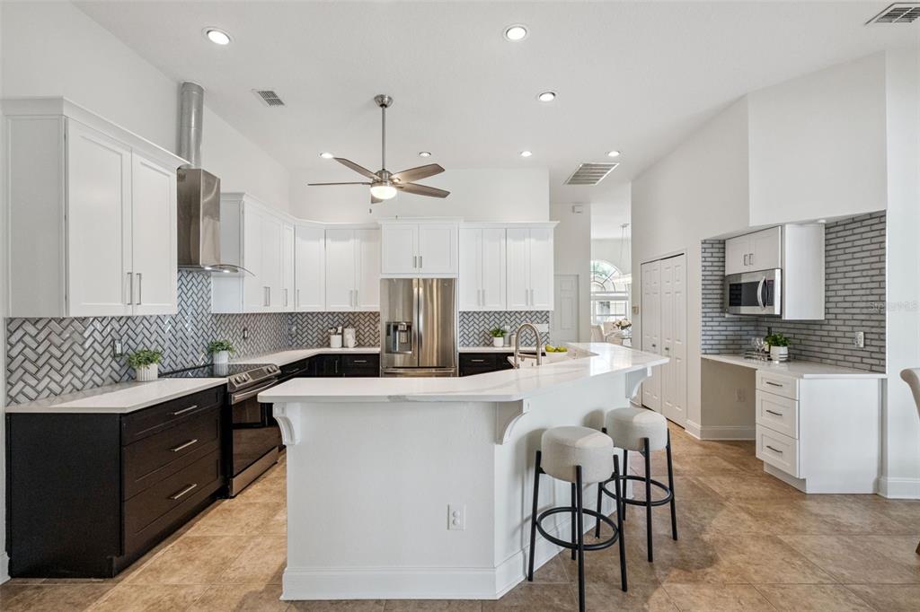 2541 Teton Stone Run Orlando, FL 32828 - Photo 5 of 82 a kitchen that has a lot of cabinets in it and appliances