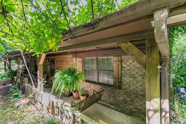 a bedroom with furniture and a large window
