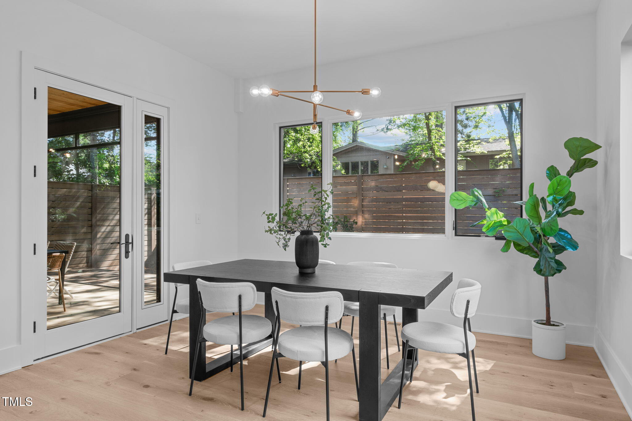 1406 Lyon Street, Unit 101 Raleigh, NC 27608 - Photo 11 of 62 a dining room with furniture potted plants and wooden floor