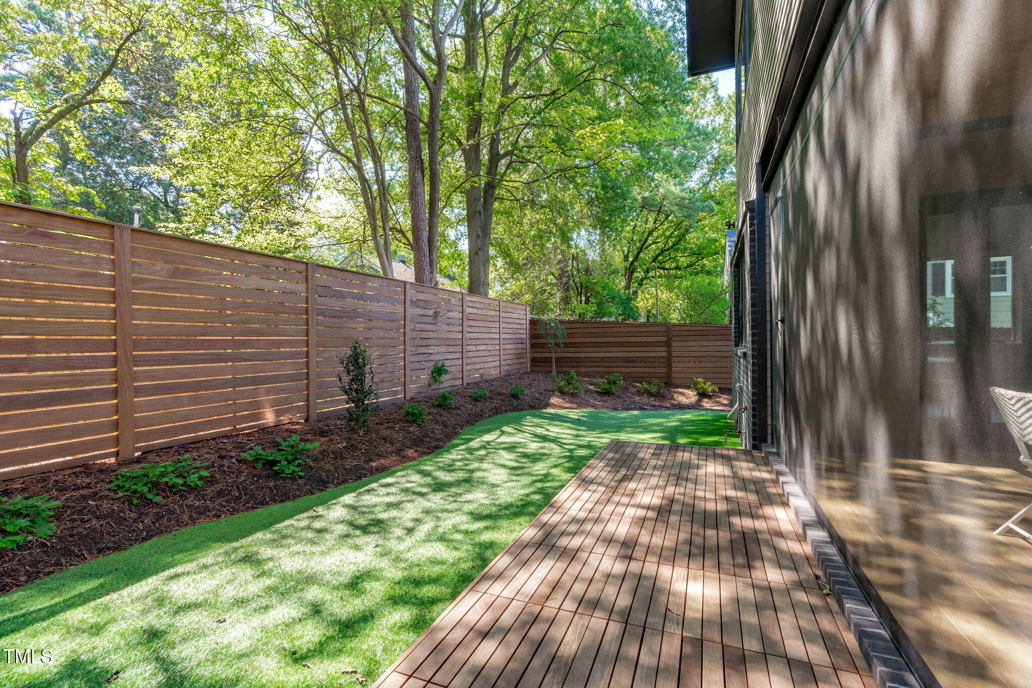 1406 Lyon Street, Unit 101 Raleigh, NC 27608 - Photo 13 of 62 a backyard of a house with lots of green space