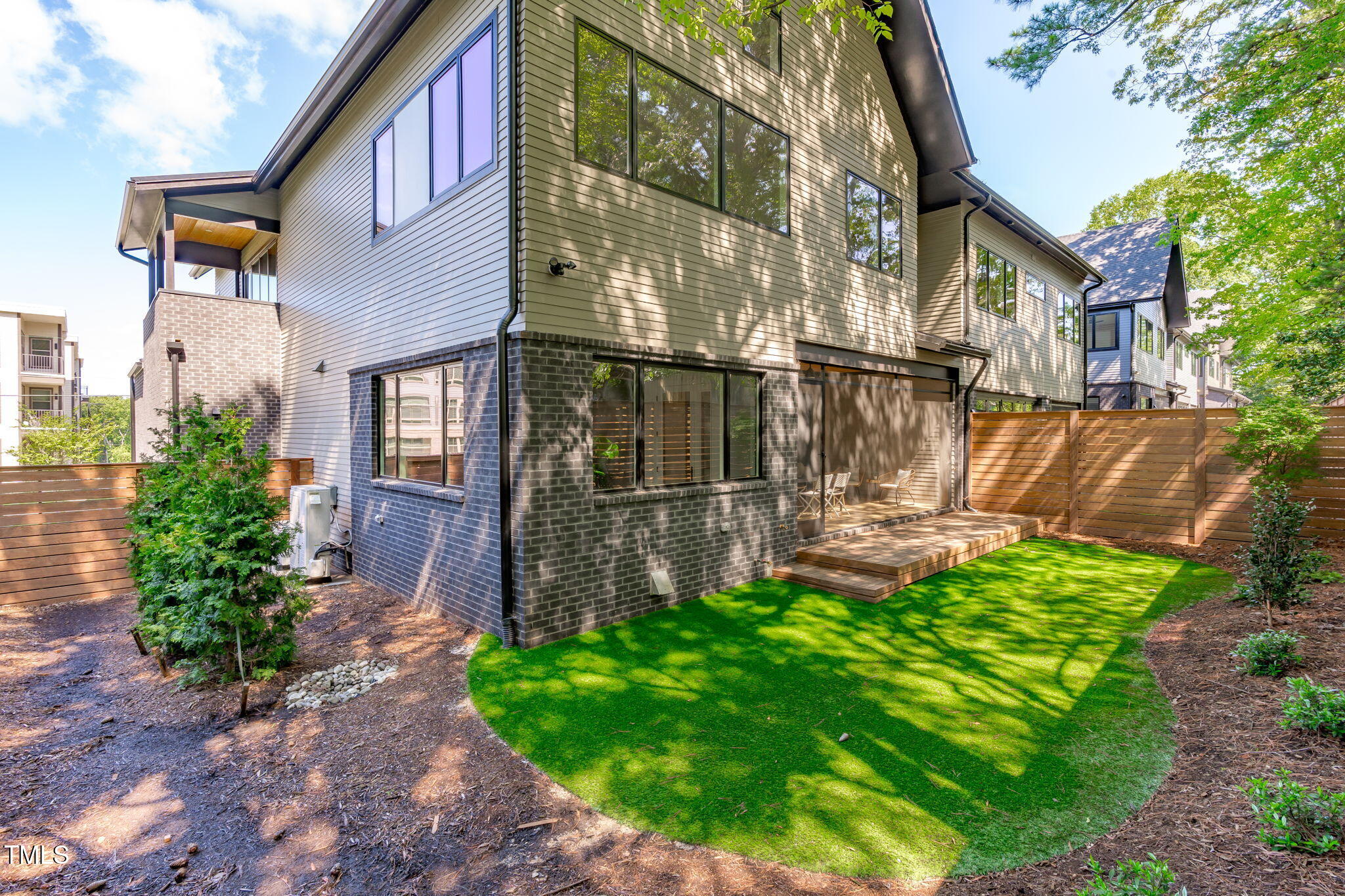 1406 Lyon Street, Unit 101 Raleigh, NC 27608 - Photo 14 of 62 a front view of a house with garden