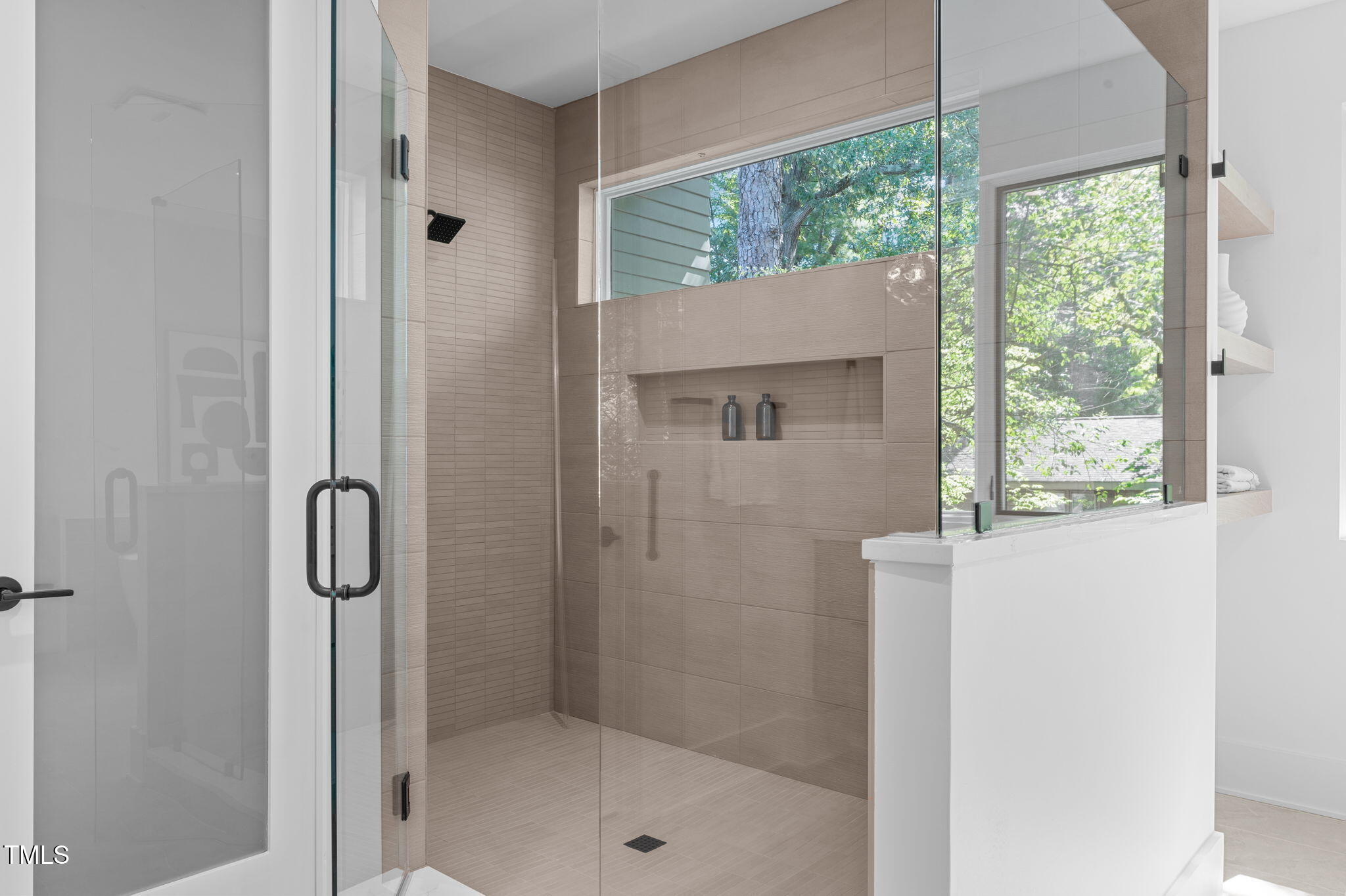 1406 Lyon Street, Unit 101 Raleigh, NC 27608 - Photo 29 of 62 a bathroom with a glass shower door