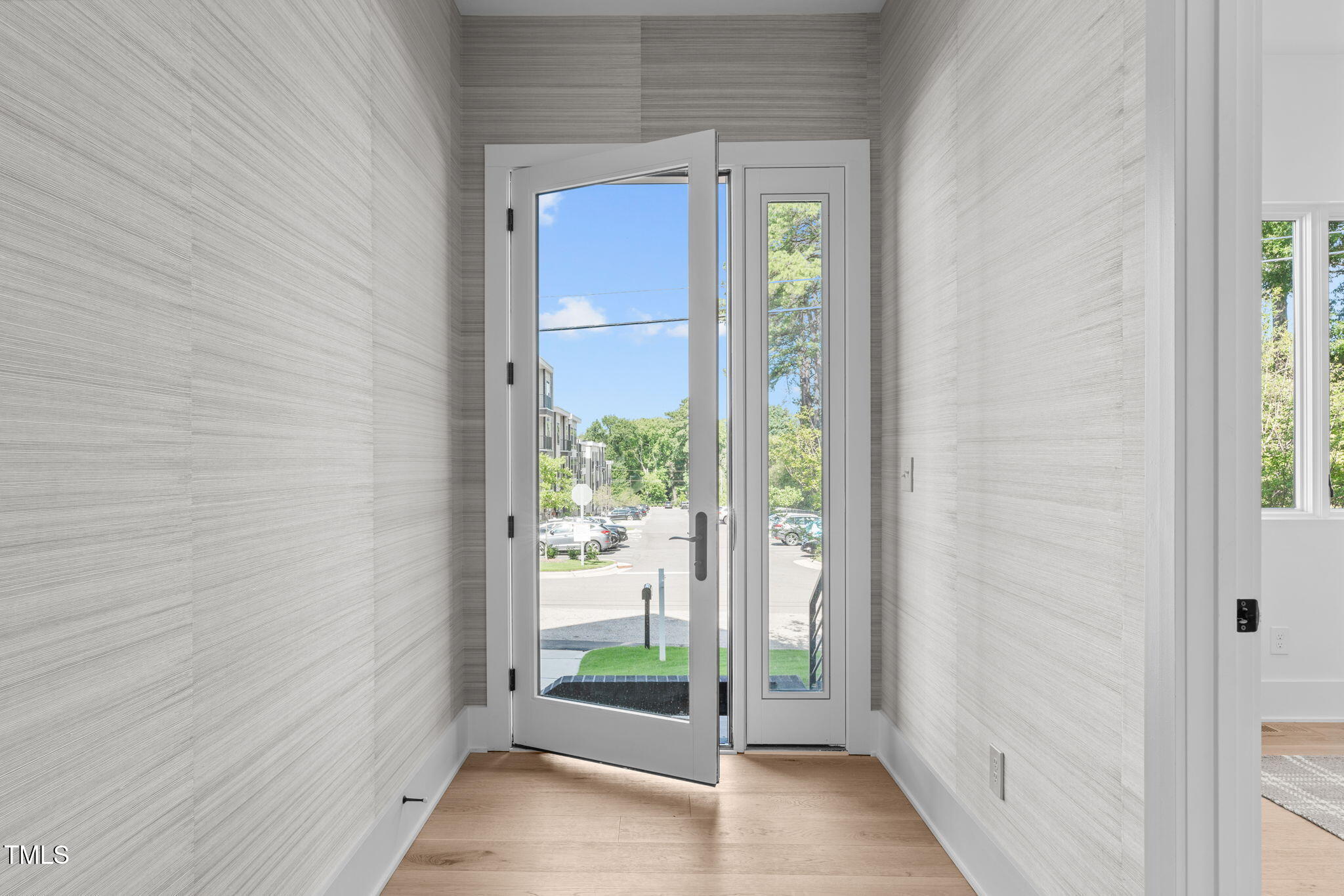 1406 Lyon Street, Unit 101 Raleigh, NC 27608 - Photo 52 of 62 a view of a hallway with a glass door and a window
