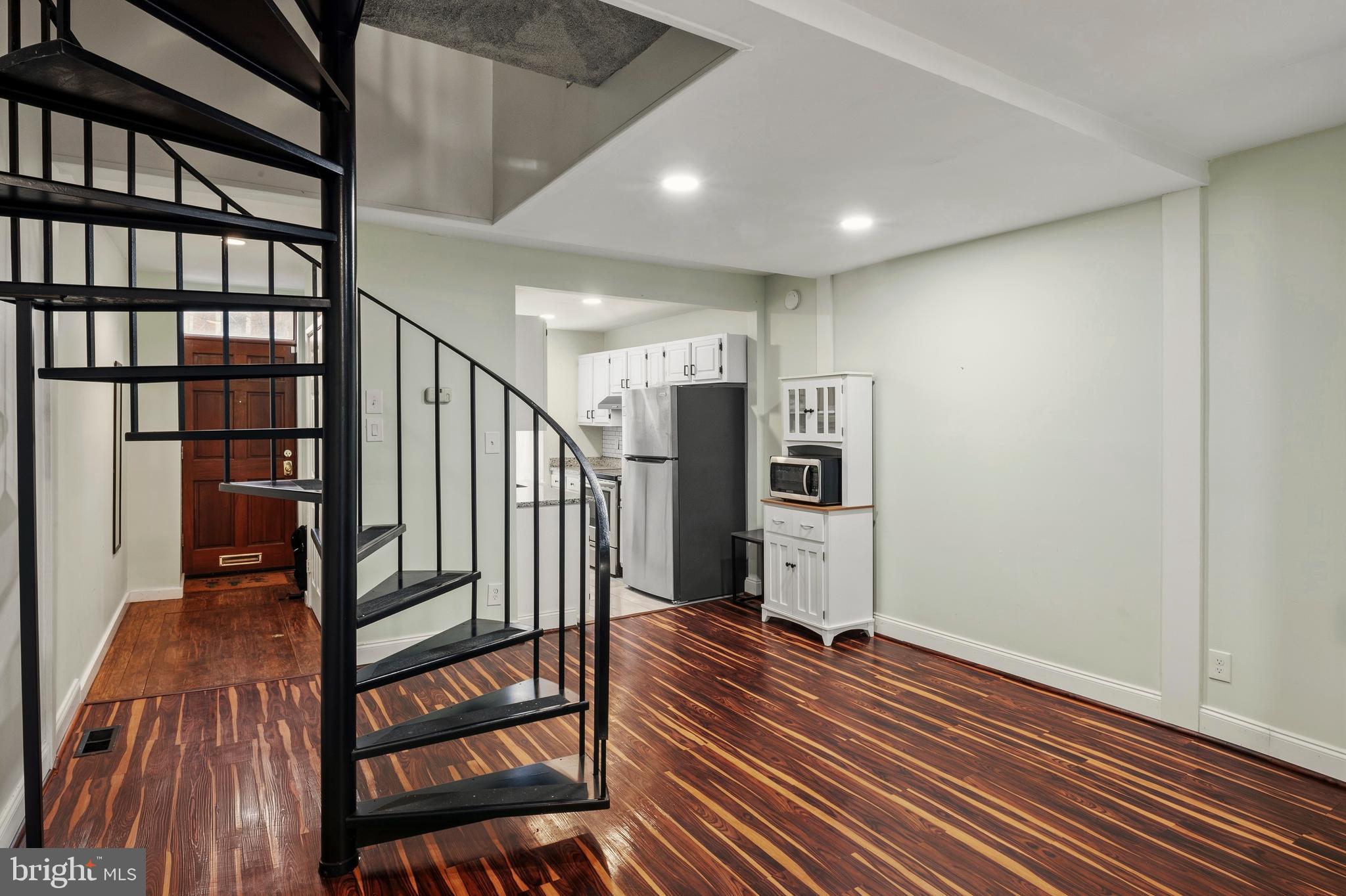 636 Portland Street Baltimore, MD 21230 - Photo 6 of 20 a view of entryway with stairs and wooden floor