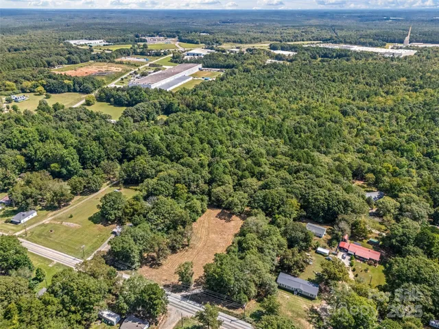 an aerial view of a houses with a yard