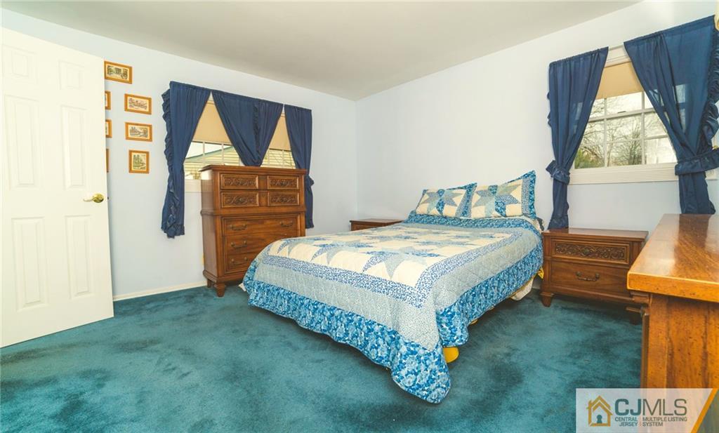 110 Princeton Road Old Bridge, NJ 08859 - Photo 12 of 19 a bedroom with a bed and dresser with mirror