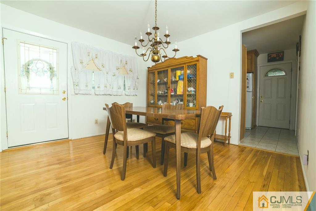 110 Princeton Road Old Bridge, NJ 08859 - Photo 10 of 19 a dining room with chandelier and wooden floor