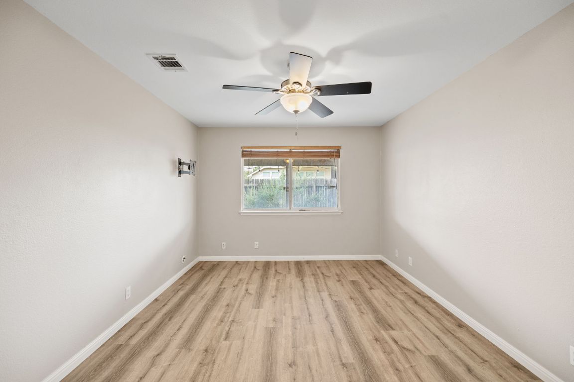 413 Clarks Way Hutto, TX 78634 - Photo 14 of 34 Empty room featuring light wood-style flooring and a ceiling fan