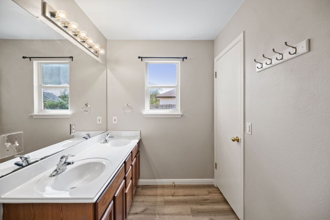 413 Clarks Way Hutto, TX 78634 - Photo 15 of 34 Bathroom featuring light wood-style flooring and double vanity