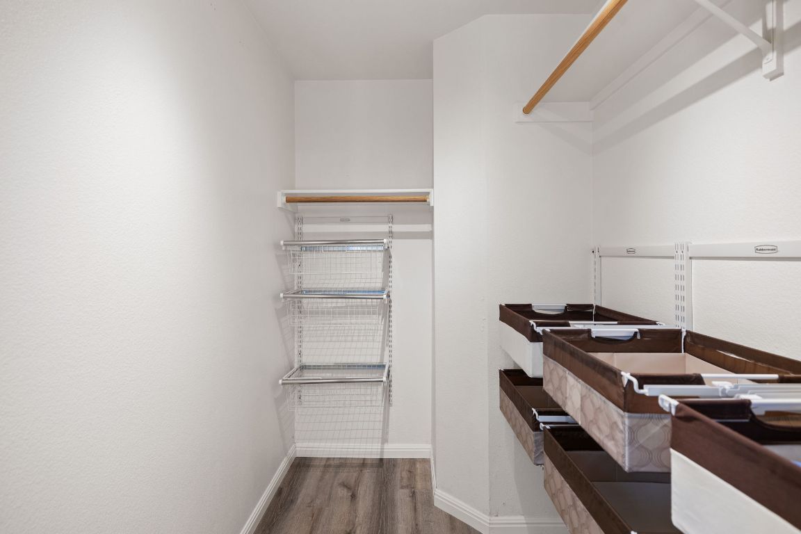 413 Clarks Way Hutto, TX 78634 - Photo 17 of 34 Walk in closet featuring dark wood-type flooring