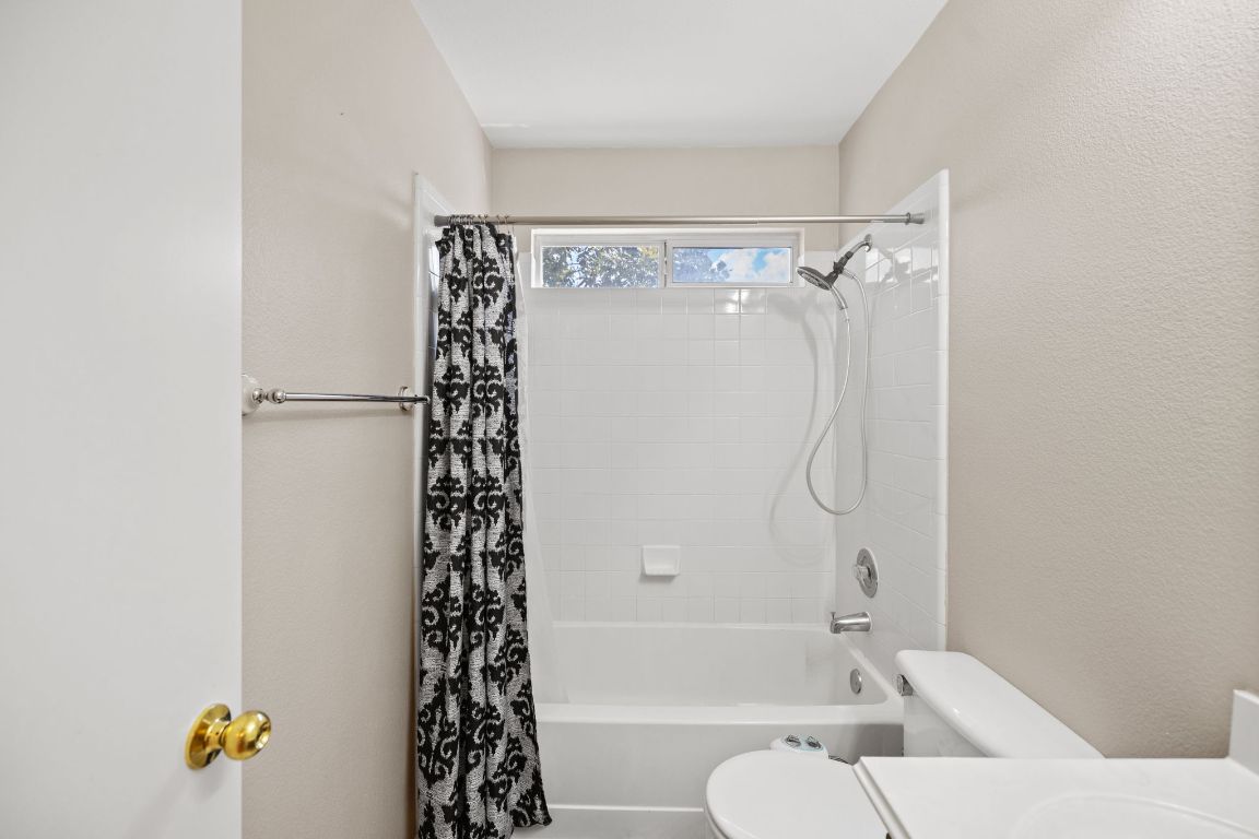 413 Clarks Way Hutto, TX 78634 - Photo 23 of 34 Bathroom with shower / tub combo, vanity, and a textured wall