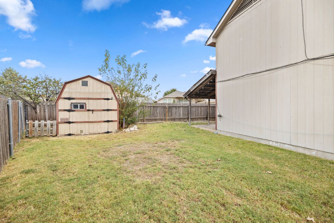 413 Clarks Way Hutto, TX 78634 - Photo 26 of 34 Fenced backyard featuring a shed