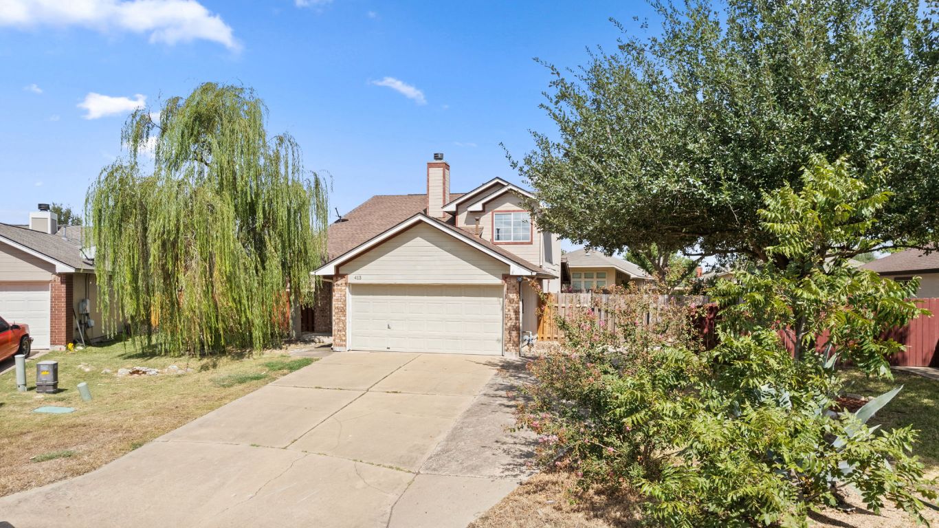 413 Clarks Way Hutto, TX 78634 - Photo 32 of 34 View of front of home featuring concrete driveway, a chimney, and a garage