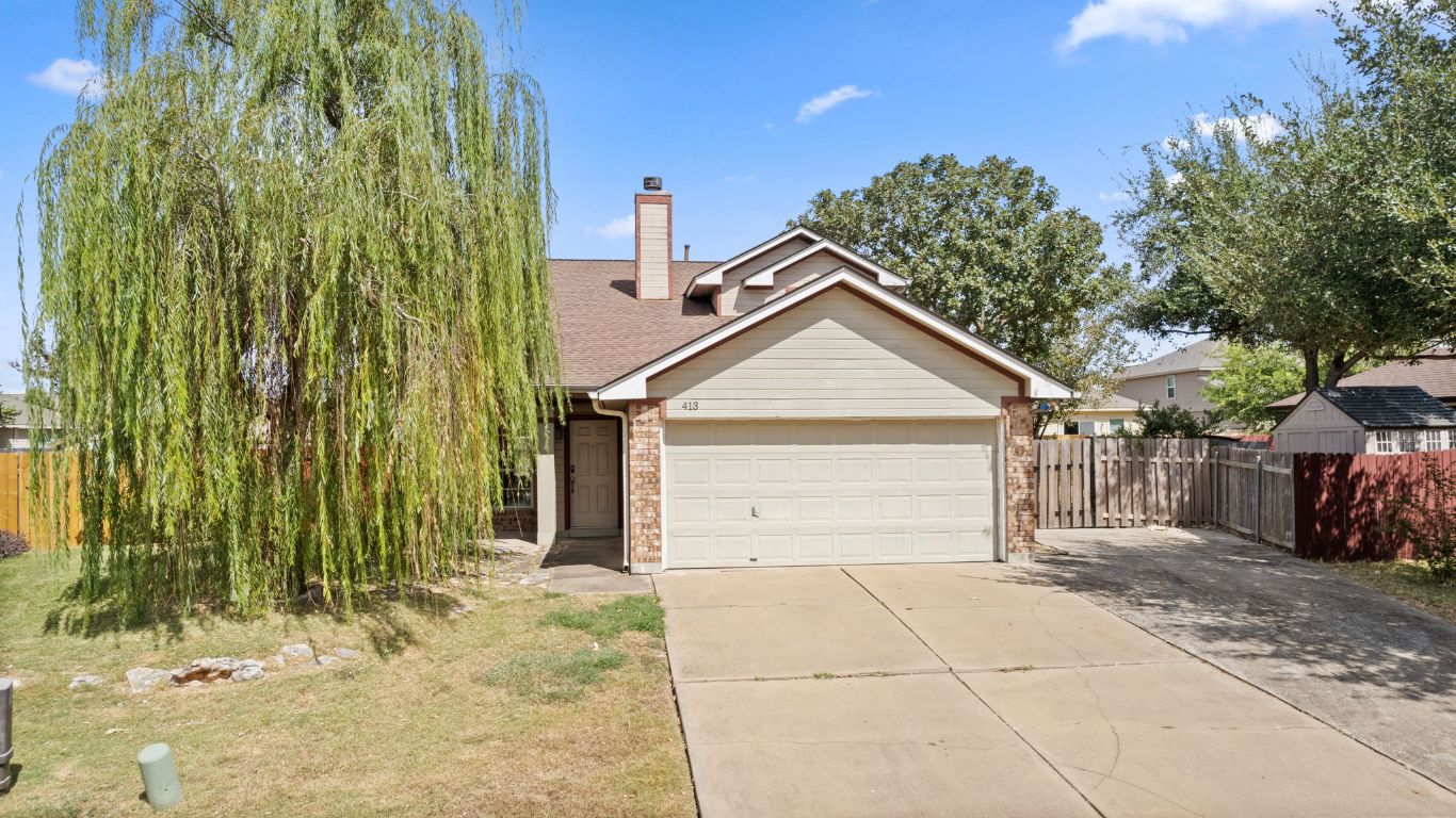 413 Clarks Way Hutto, TX 78634 - Photo 5 of 34 View of front of house with driveway, brick siding, a chimney, a garage, and a shingled roof