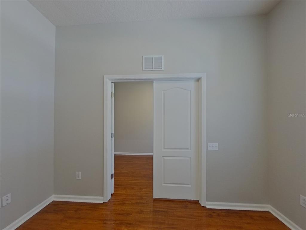 Undisclosed Address Land O Lakes, FL 34638 - Photo 14 of 18 a view of an empty room with wooden floor