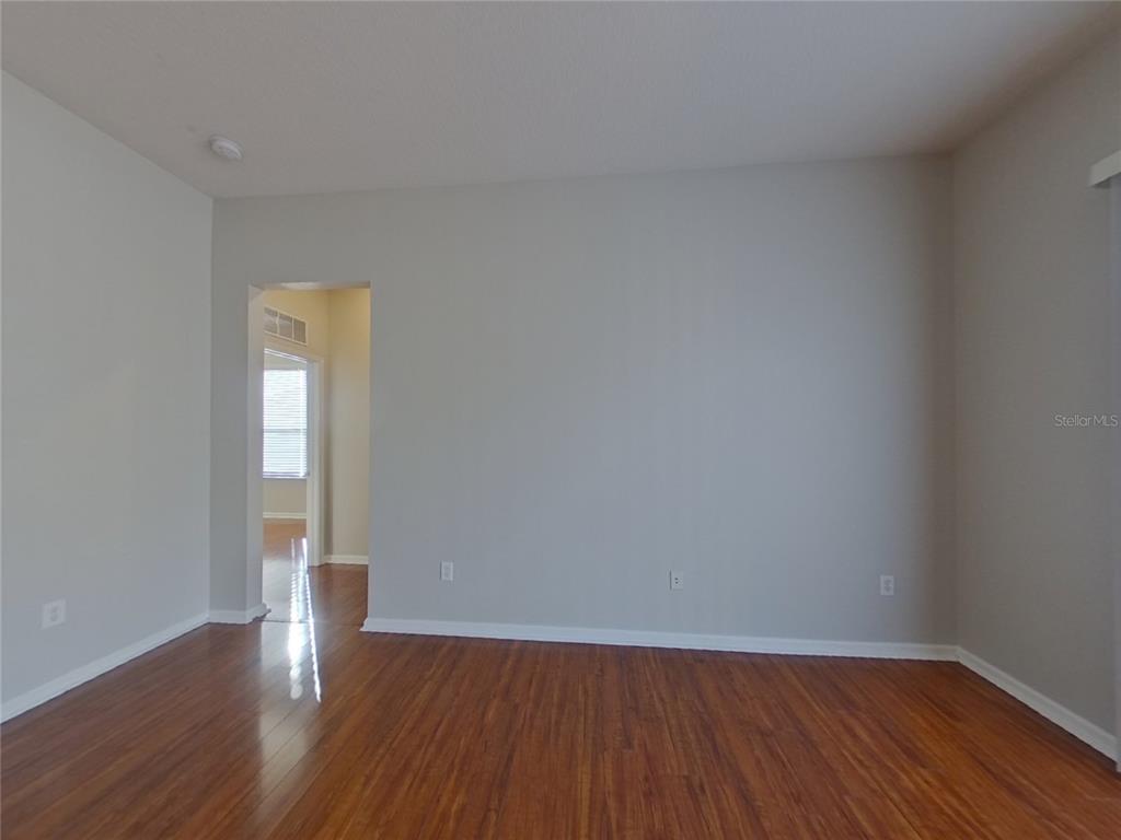 Undisclosed Address Land O Lakes, FL 34638 - Photo 3 of 18 a view of wooden floor and windows in a room