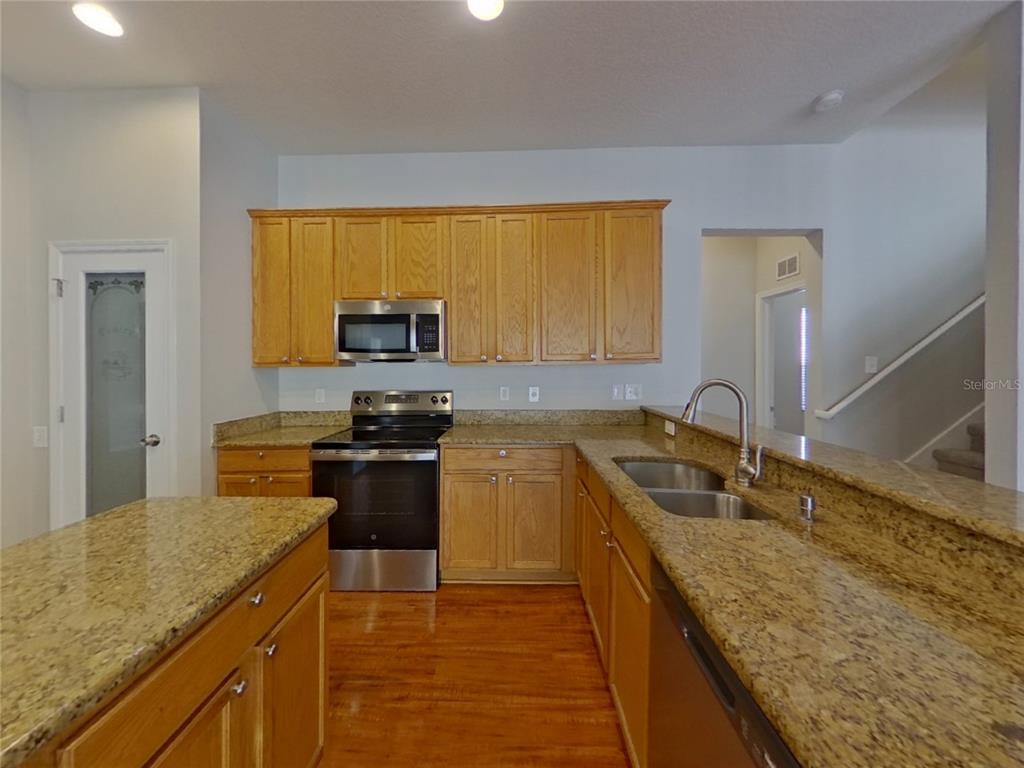 Undisclosed Address Land O Lakes, FL 34638 - Photo 4 of 18 a kitchen with a sink stove and microwave