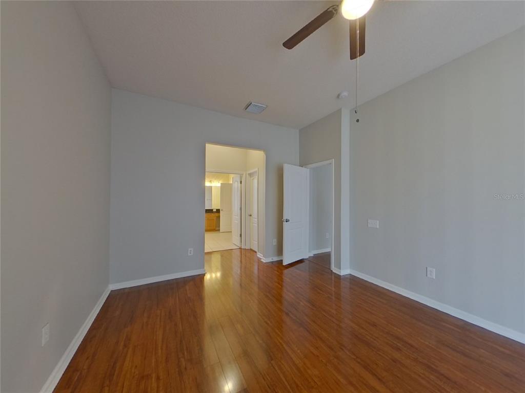 Undisclosed Address Land O Lakes, FL 34638 - Photo 5 of 18 wooden floor in an empty room with a window