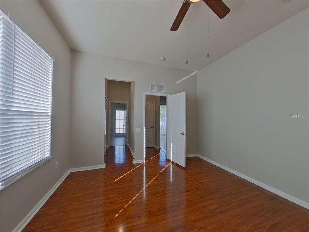 Undisclosed Address Land O Lakes, FL 34638 - Photo 8 of 18 wooden floor in an empty room with a window