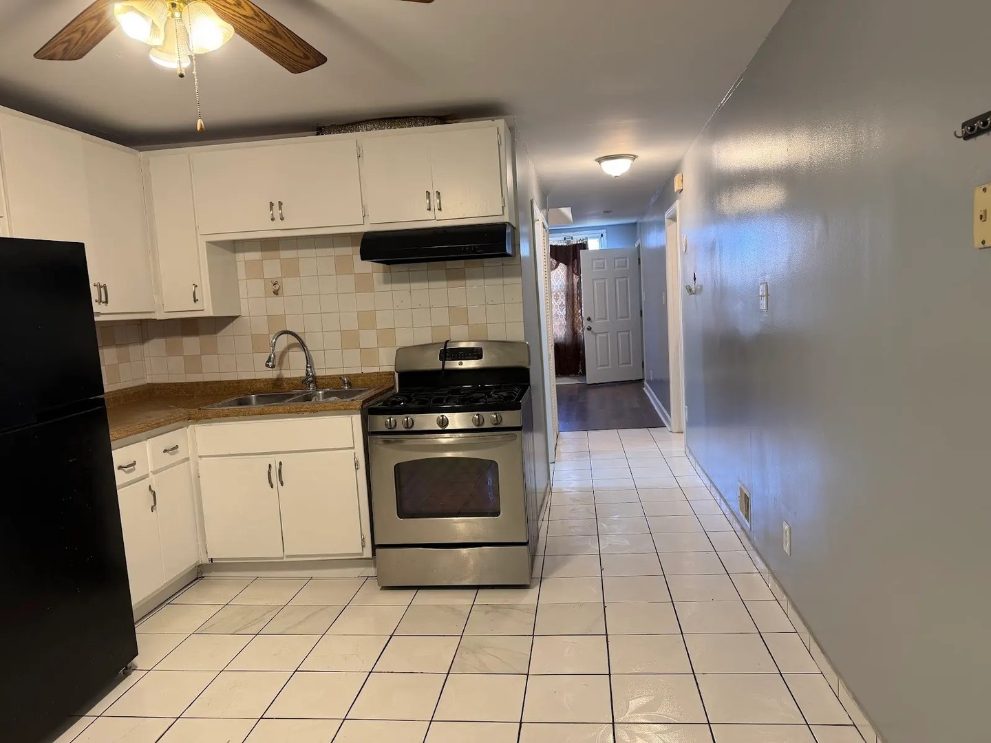 3033 South Kenneth Avenue Chicago, IL 60623 - Photo 11 of 43 a kitchen with a stove sink and cabinets