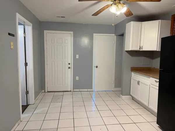 a view of a kitchen with white cabinets