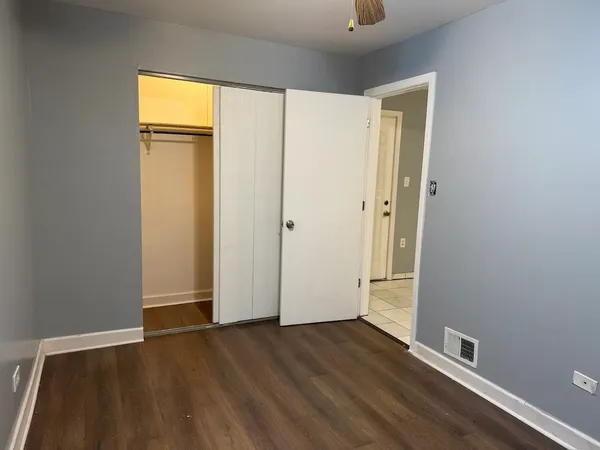 an empty room with wooden floor and a window