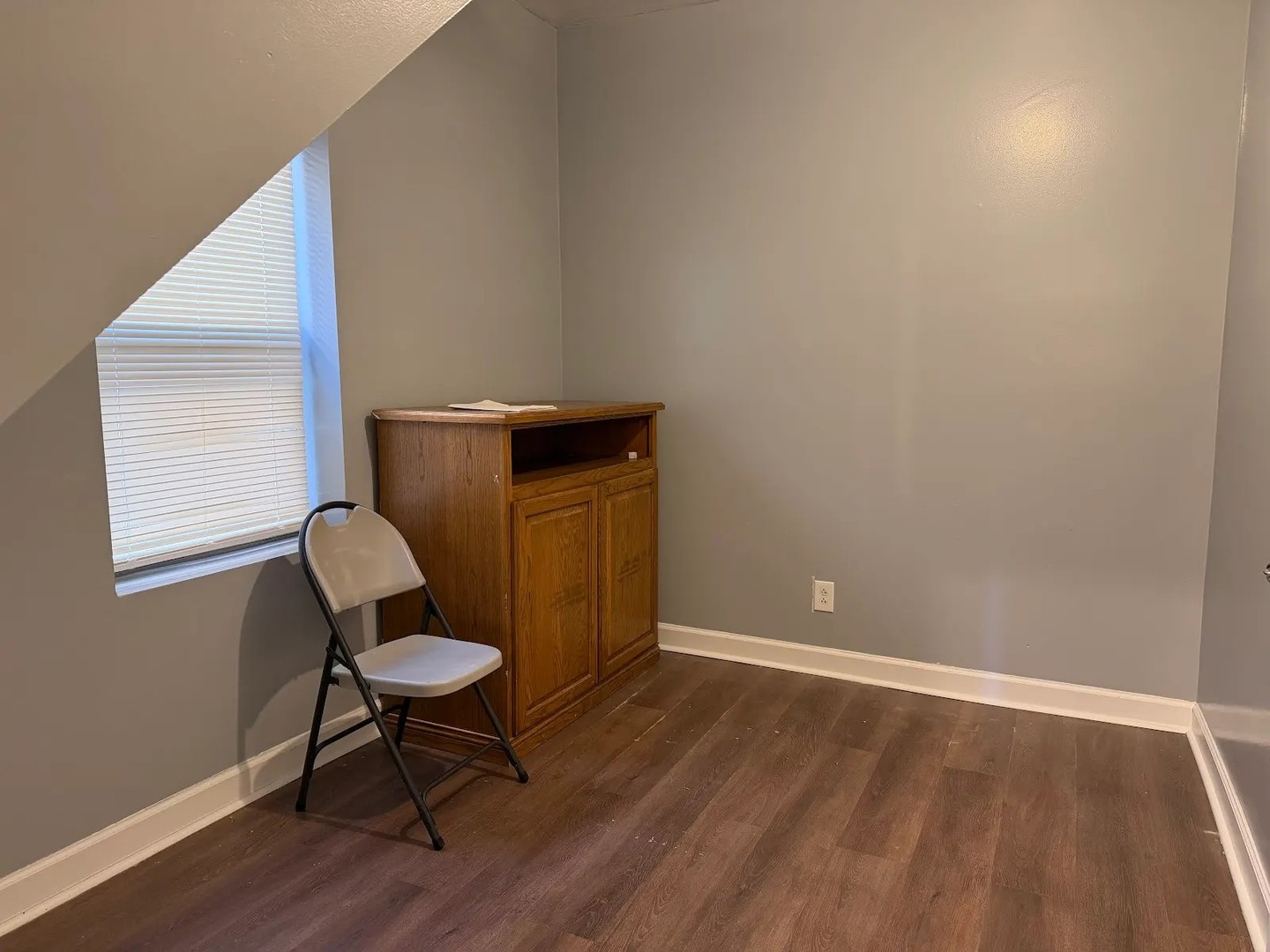 3033 South Kenneth Avenue Chicago, IL 60623 - Photo 18 of 43 a view of a workspace room with wooden floor and chair
