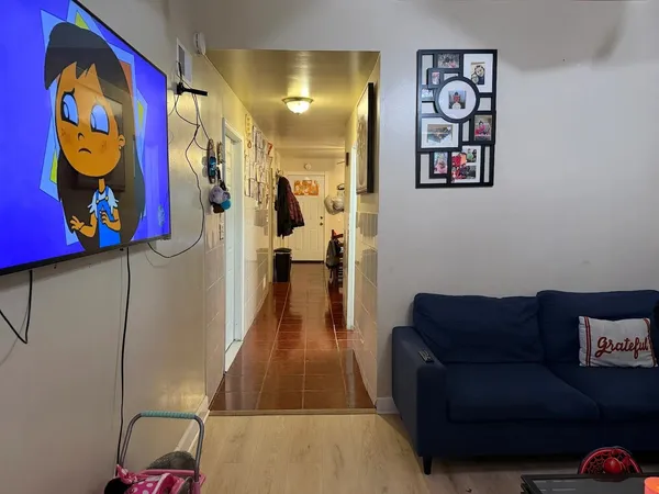 a living room with furniture and wall painting