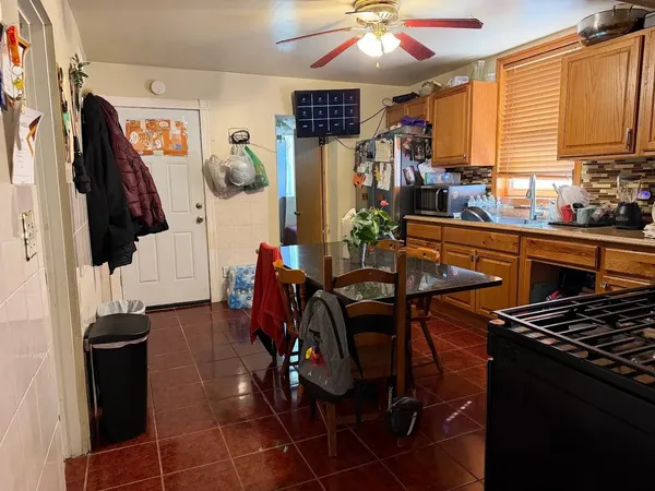 a view of a dining room with furniture and a kitchen