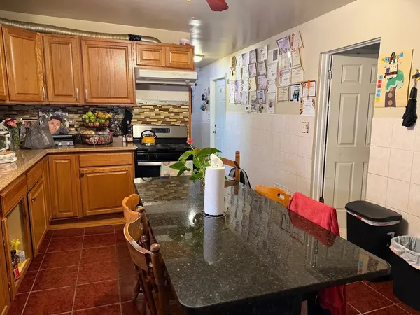 a kitchen with stainless steel appliances granite countertop a sink refrigerator and cabinets