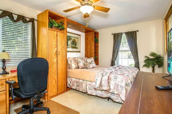 a bedroom with bed and a window