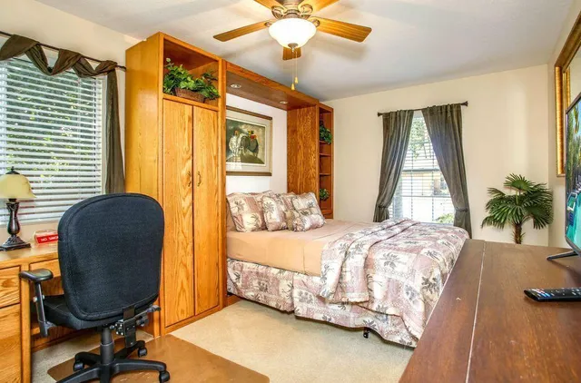 a bedroom with bed and a window