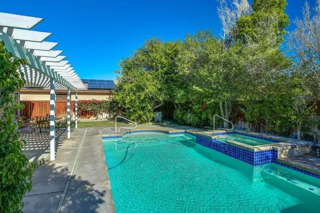 a view of a backyard with swimming pool