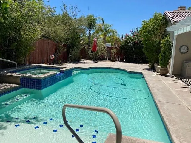 swimming pool view with a seating space