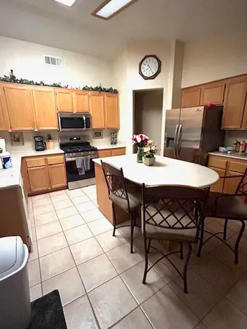 a kitchen with a dining table and chairs