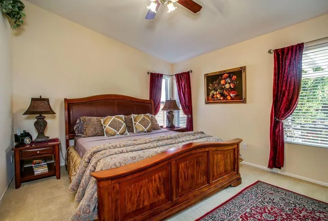 a bedroom with a bed and a chandelier