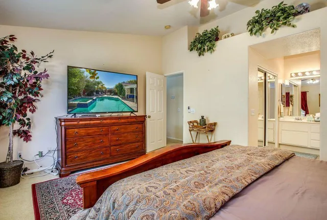 a bedroom with a bed and a painting on the wall