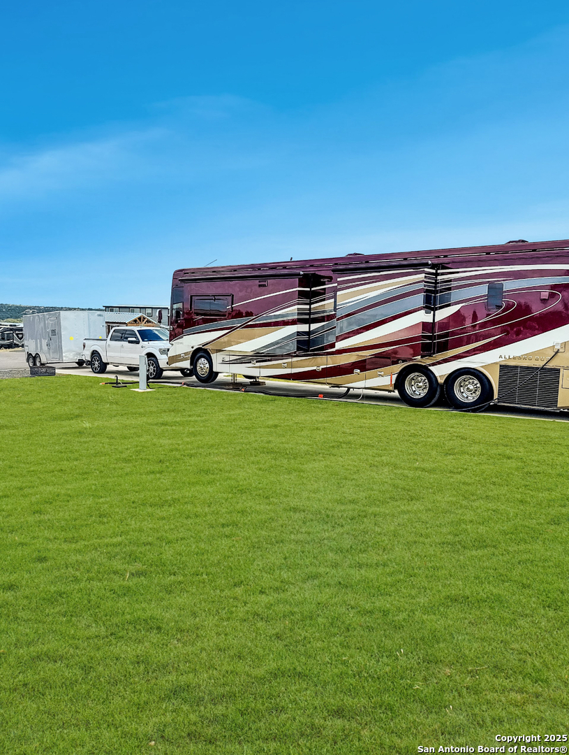 5386 Ranch Road 1376, Unit 232 Fredericksburg, TX 78624 - Photo 7 of 13 a view of a big yard with table and chairs